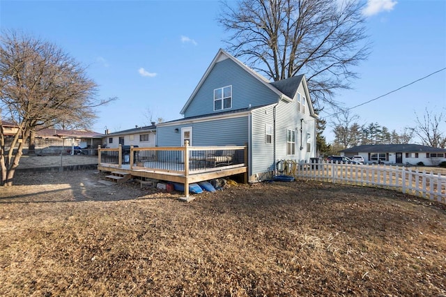 back of property featuring a wooden deck