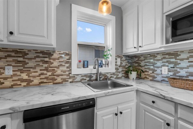 kitchen with tasteful backsplash, appliances with stainless steel finishes, sink, and white cabinets