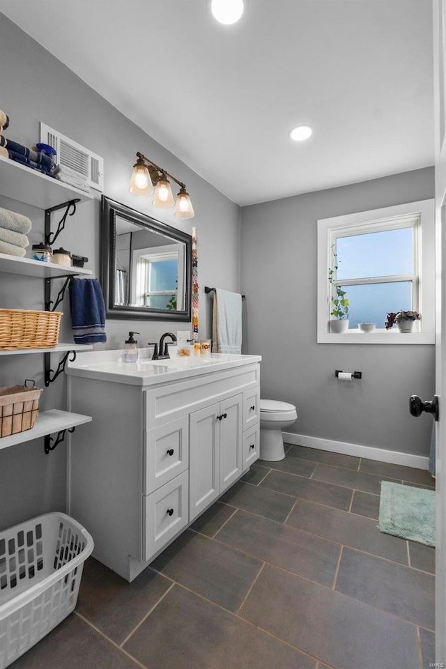 bathroom featuring vanity and toilet