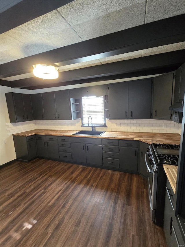 kitchen with dark hardwood / wood-style flooring, sink, wood counters, and stainless steel gas stove