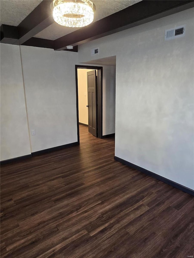 unfurnished room with beamed ceiling and dark hardwood / wood-style floors