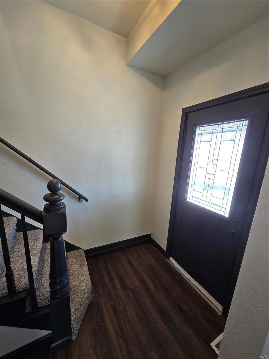 foyer entrance with dark hardwood / wood-style floors