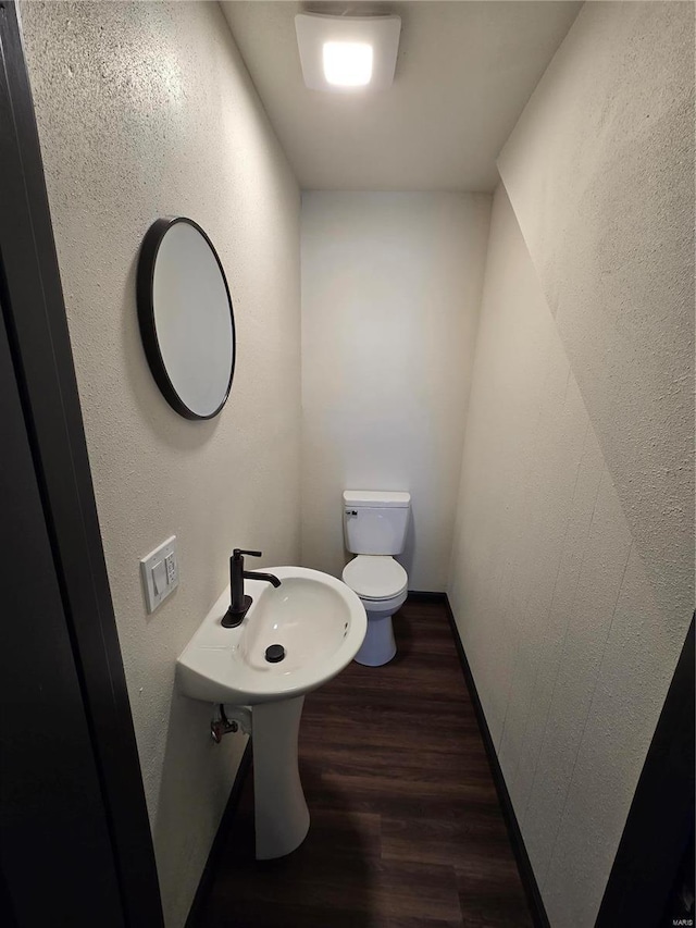 bathroom featuring hardwood / wood-style floors and toilet