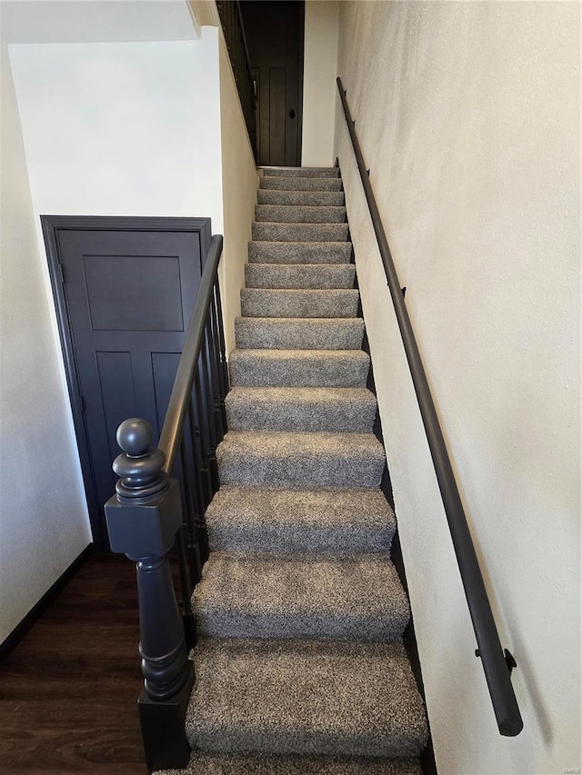 staircase featuring hardwood / wood-style flooring