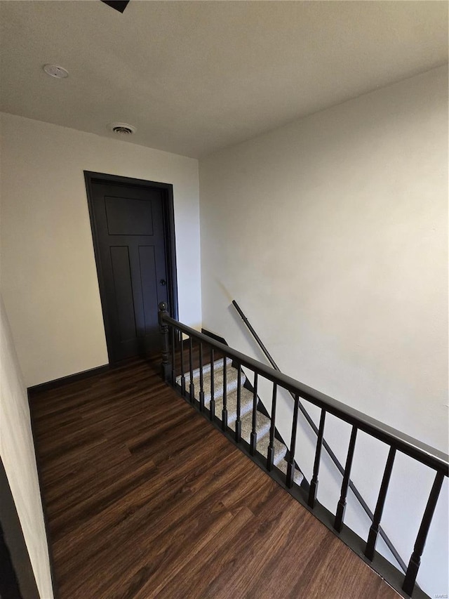 stairway with hardwood / wood-style floors