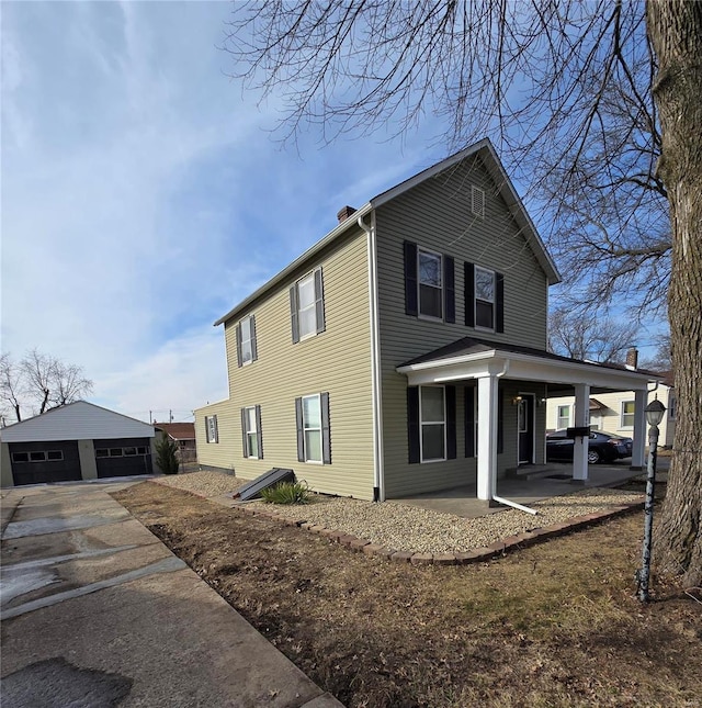 view of home's exterior featuring a garage, an outdoor structure, and covered porch