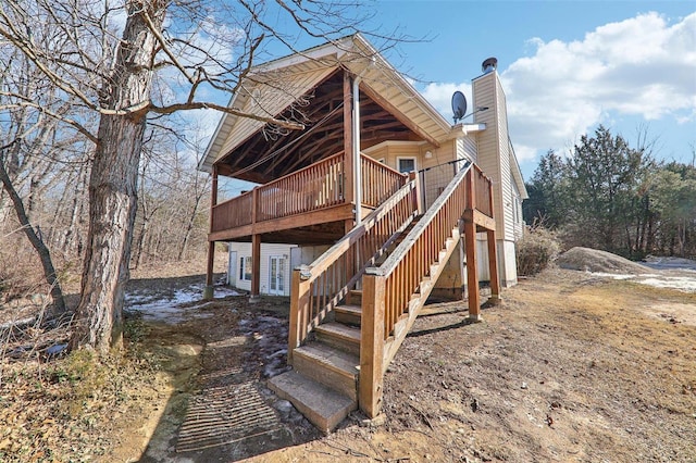 back of property with a wooden deck