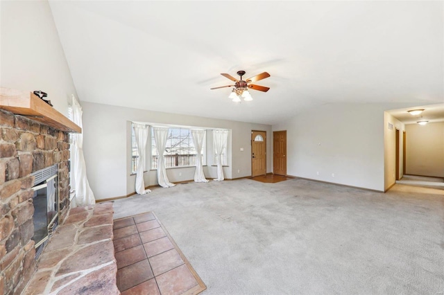 unfurnished living room with ceiling fan, lofted ceiling, carpet floors, and a fireplace