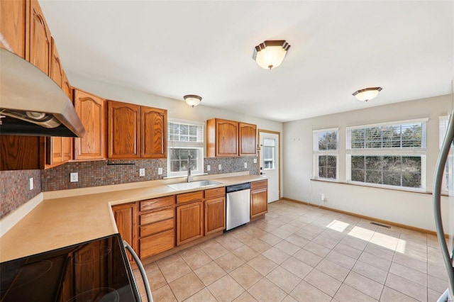 kitchen with tasteful backsplash, light tile patterned flooring, appliances with stainless steel finishes, and sink