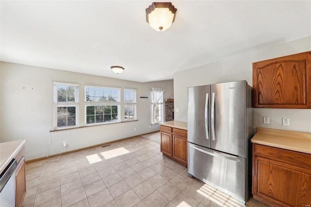 kitchen featuring appliances with stainless steel finishes and light tile patterned floors