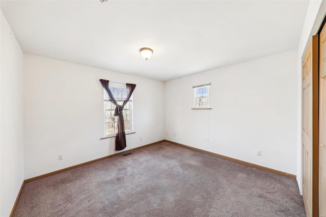 carpeted empty room with a wealth of natural light