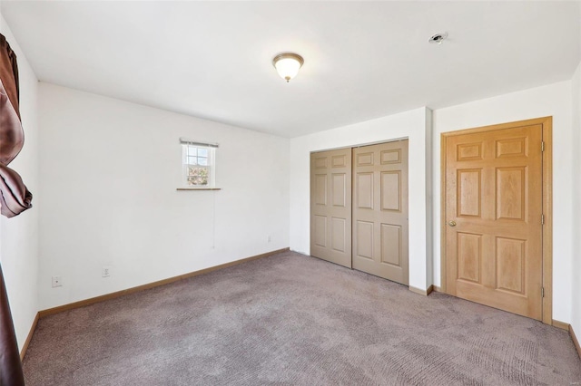 unfurnished bedroom with carpet floors and a closet