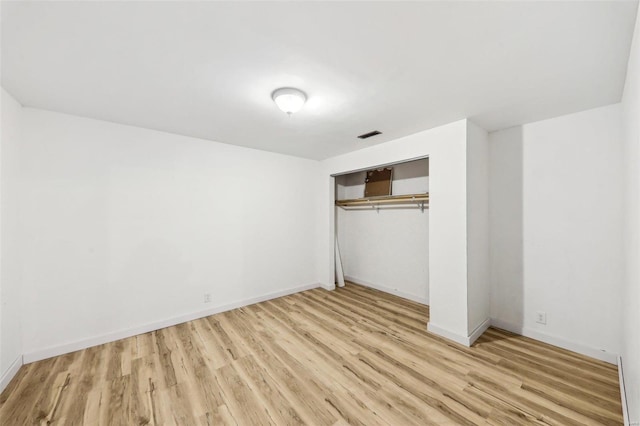 unfurnished bedroom with light hardwood / wood-style floors and a closet