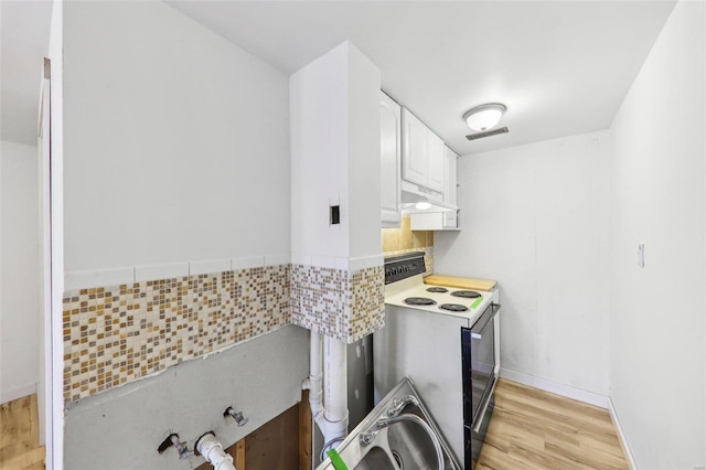 kitchen featuring white cabinetry, light wood-type flooring, and electric stove