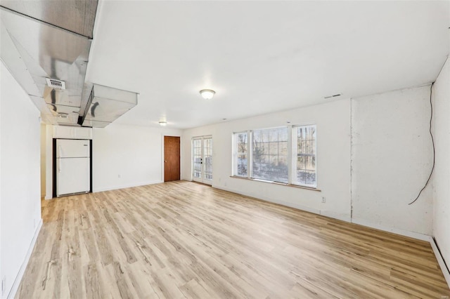 unfurnished room with light hardwood / wood-style flooring