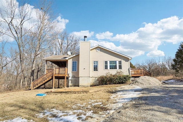 view of side of property with a wooden deck