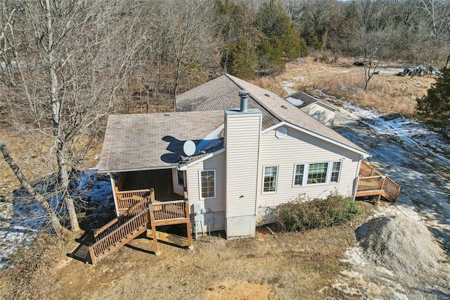 rear view of property featuring a wooden deck