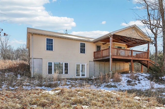 snow covered house featuring a deck