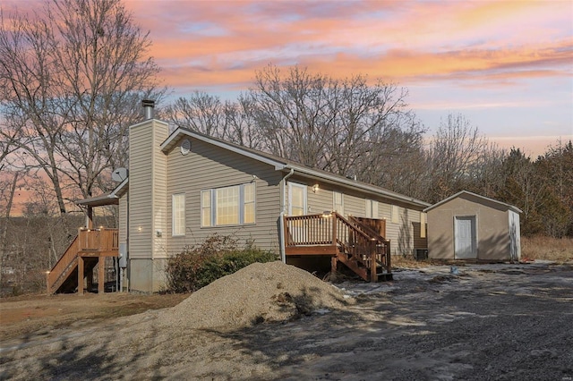 property exterior at dusk with a storage shed