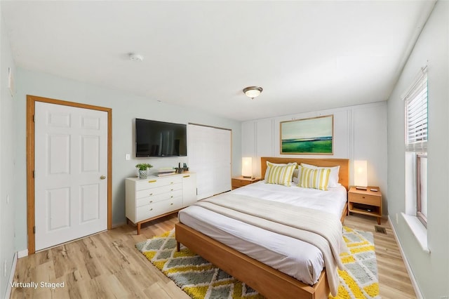 bedroom with a closet and light hardwood / wood-style flooring