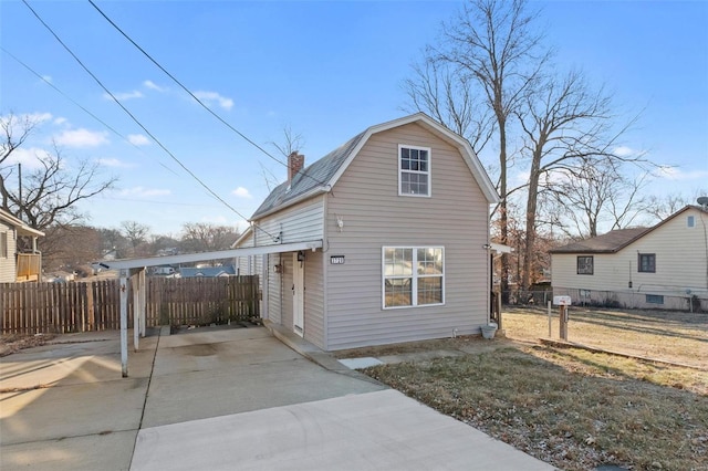 exterior space featuring a carport and a yard