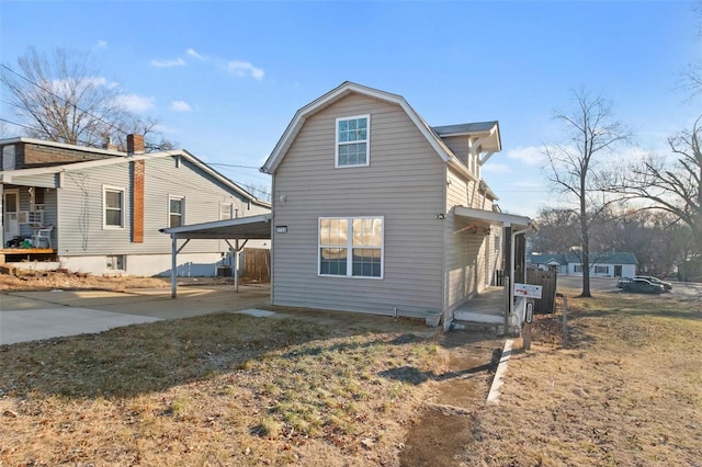 view of property exterior with a carport and a lawn