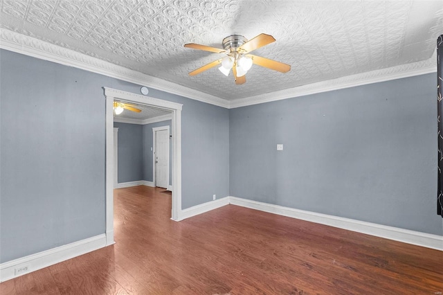 empty room featuring crown molding, ceiling fan, and wood-type flooring