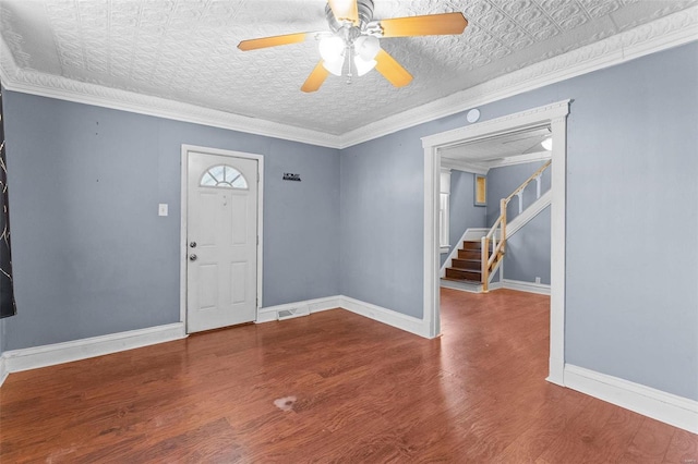 foyer entrance with crown molding, hardwood / wood-style flooring, a textured ceiling, and ceiling fan