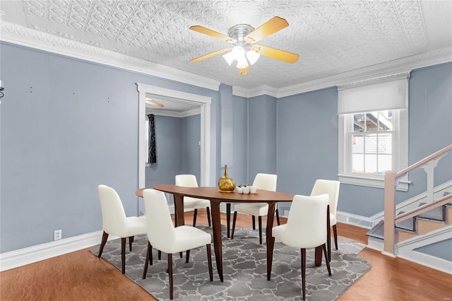 dining area featuring hardwood / wood-style floors, ornamental molding, and ceiling fan