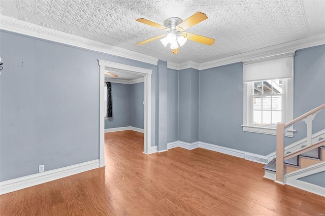 empty room featuring crown molding, ceiling fan, and hardwood / wood-style flooring