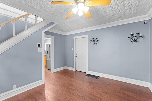 interior space with hardwood / wood-style flooring, ornamental molding, and ceiling fan