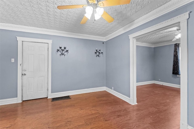 empty room with crown molding, ceiling fan, hardwood / wood-style floors, and a textured ceiling