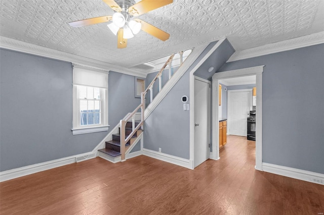 interior space featuring ornamental molding, hardwood / wood-style floors, and ceiling fan