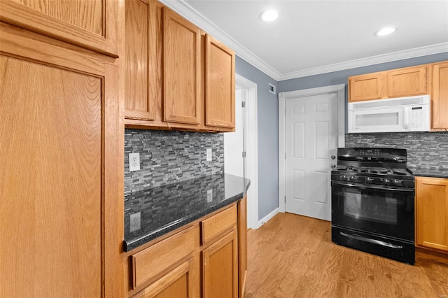 kitchen with backsplash, black range with gas stovetop, dark stone counters, crown molding, and light hardwood / wood-style flooring