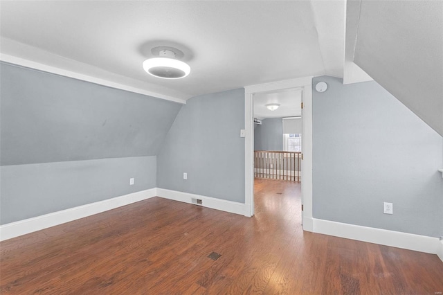 bonus room featuring hardwood / wood-style flooring and vaulted ceiling