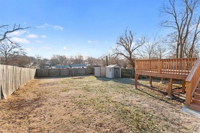 view of yard with a wooden deck and a shed