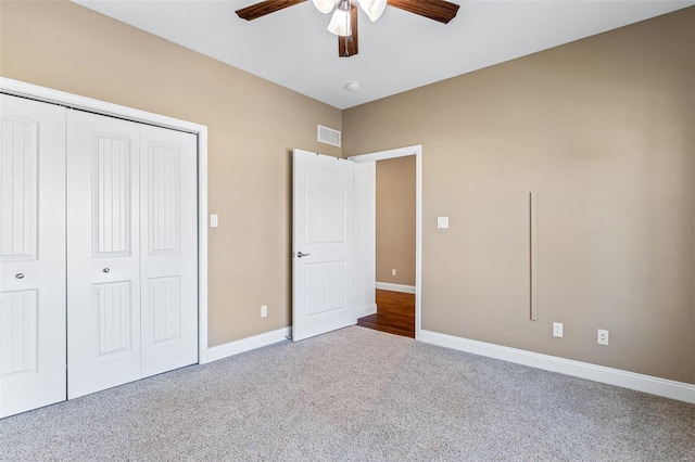 unfurnished bedroom featuring carpet flooring, a closet, and ceiling fan