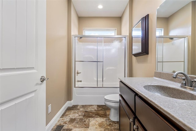 full bathroom with vanity, toilet, and combined bath / shower with glass door