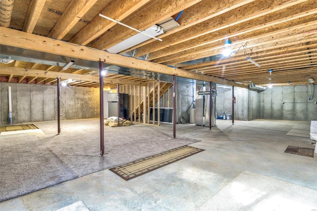 basement featuring stainless steel refrigerator