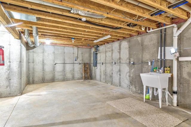 basement featuring sink and electric panel