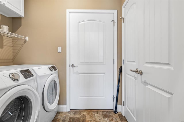 clothes washing area with independent washer and dryer and cabinets