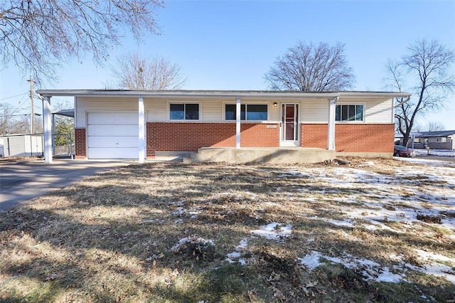 single story home featuring a porch and a garage