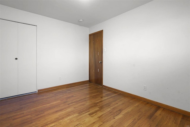 unfurnished bedroom featuring hardwood / wood-style flooring and a closet