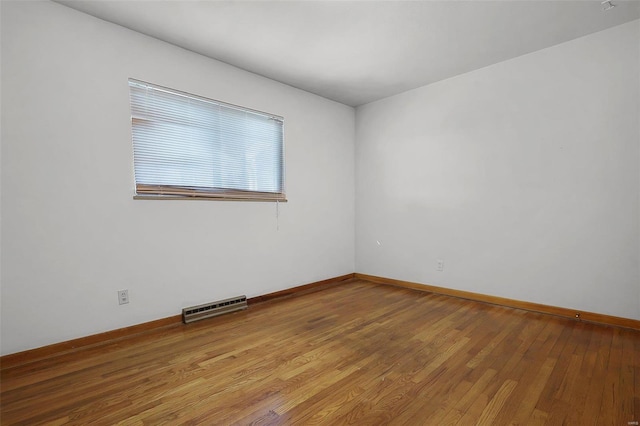 empty room with hardwood / wood-style floors