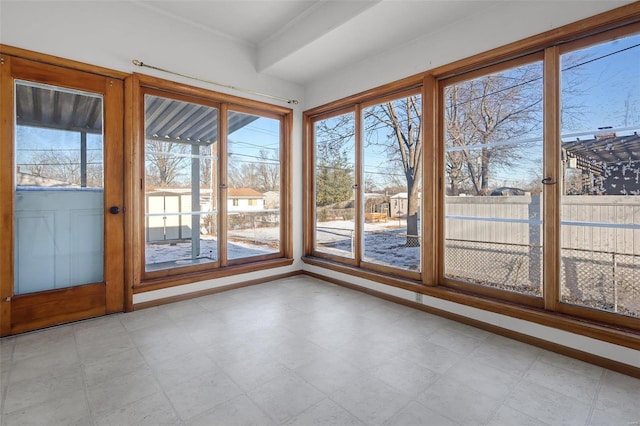 unfurnished sunroom featuring a wealth of natural light