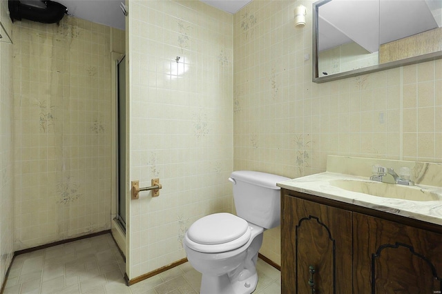 bathroom featuring an enclosed shower, toilet, vanity, and tile walls