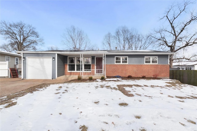 ranch-style home with a garage and a porch