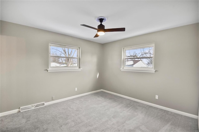 carpeted empty room featuring ceiling fan