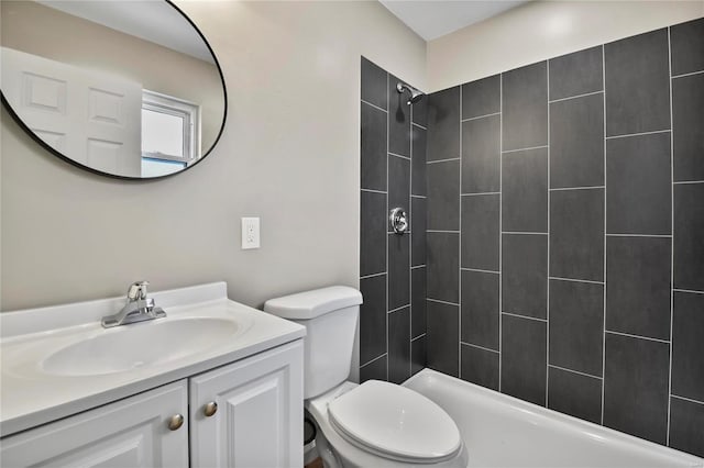 bathroom featuring vanity, toilet, and tiled shower