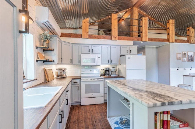 kitchen with butcher block countertops, tasteful backsplash, white appliances, dark hardwood / wood-style flooring, and sink